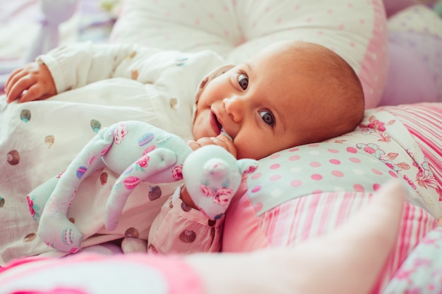 little-girl-spotted-shirt-lies-among-pink-pillows_1304-4777.jpg