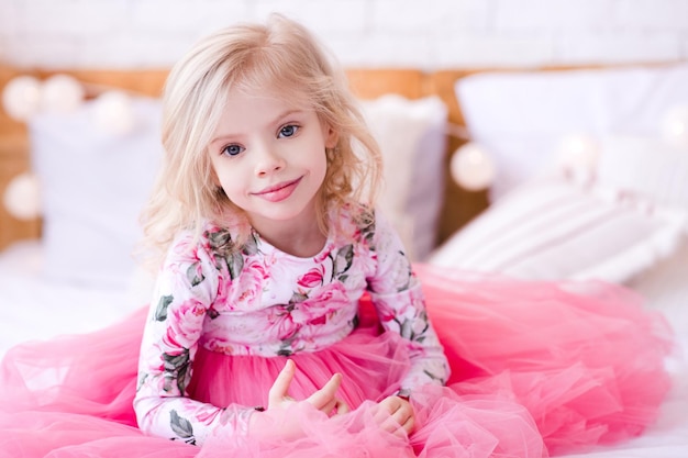smiling-princess-baby-girl-wearing-stylish-pink-dress-sitting-bed_260913-1171.jpg
