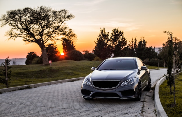 grey-luxury-sedan-car-sunset_114579-4045.jpg