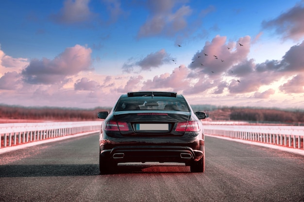 luxurious-black-car-riding-street-with-beautiful-sky_181624-33018.jpg