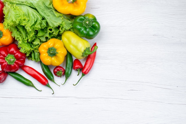 top-view-fresh-green-salad-along-withful-bell-peppers-spicy-peppers-light-desk-vegetable-food-meal-ingredient_140725-34341.jpg