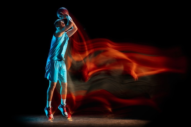 male-basketball-player-playing-basketball-isolated-dark-studio-wall-mixed-light_155003-41431.jpg