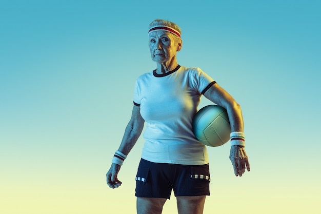 senior-woman-sportwear-training-volleyball-gradient-background-neon-light-female-model-great-shape-stays-active-concept-sport-activity-movement-wellbeing-confidence-copyspace_155003-34315.jpg